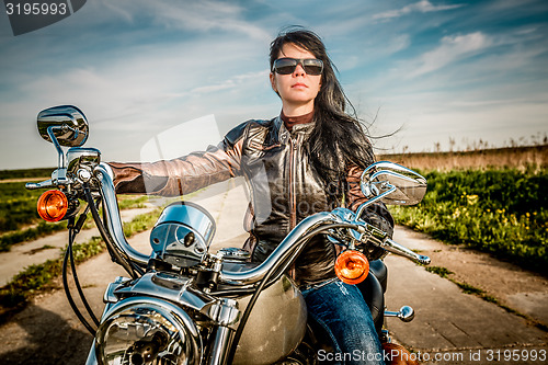 Image of Biker girl on a motorcycle