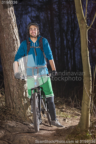 Image of proud mountainbiker in the forest