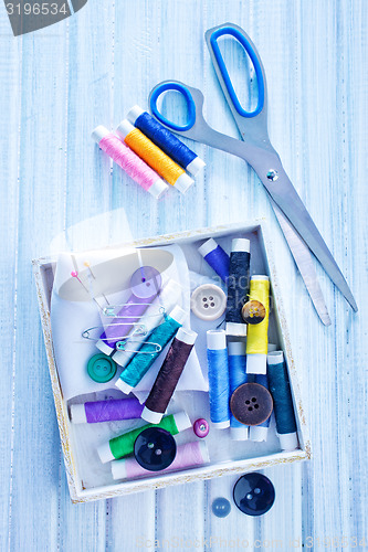 Image of Scissors, bobbins with thread and needles