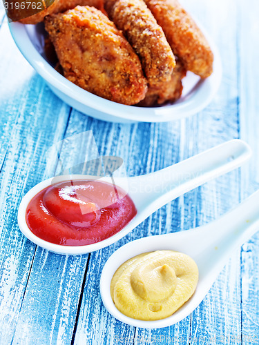 Image of sauce and chicken wings