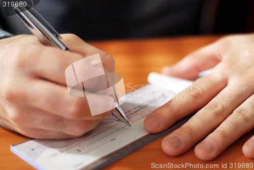 Image of Man writing a check