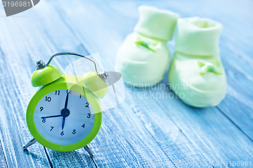 Image of clock and baby socks