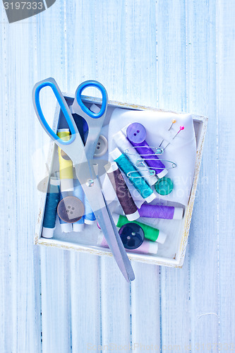 Image of Scissors, bobbins with thread and needles