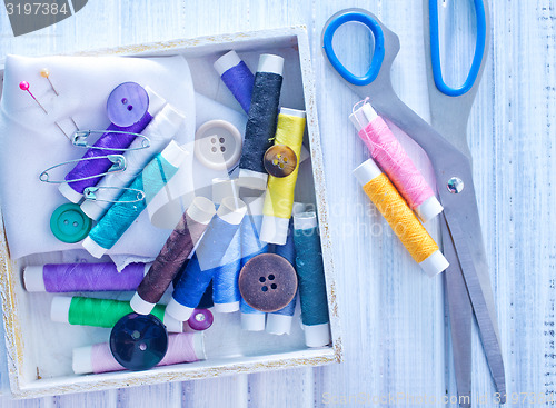 Image of Scissors, bobbins with thread and needles