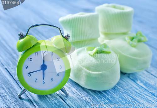 Image of clock and baby socks