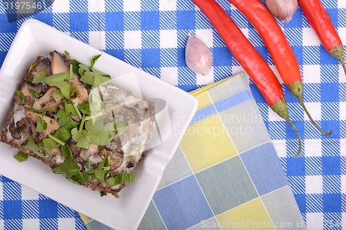 Image of mushroom salad and red pepper on white plate