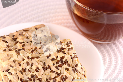 Image of sweet cake on white plate with tea (coffee) cup