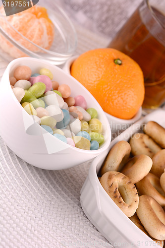Image of candies and fruits, tea (coffee) cup and fruits