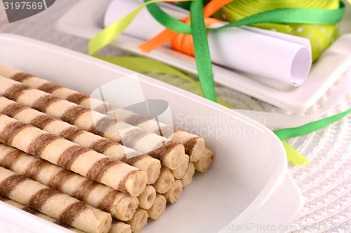 Image of sweet cake on white plate with ribbons