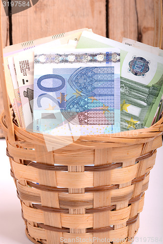 Image of money set in a basket, dollars, euro and ukrainian money