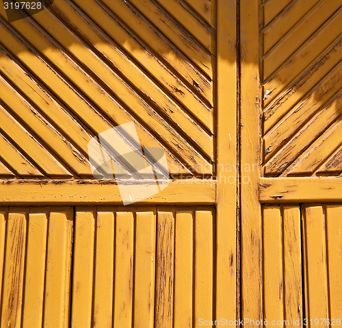 Image of abstract samarate   rusty   door curch  closed wood lombardy ita