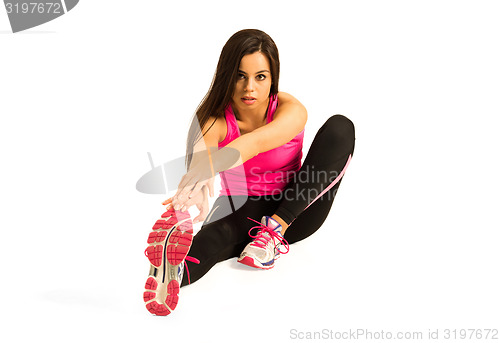 Image of Young woman stretching her leg 