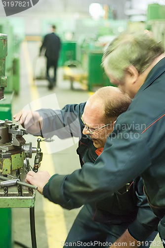 Image of Industrial workers working in plant, teamwork