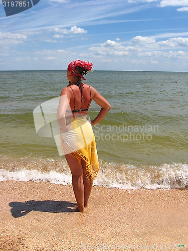 Image of The girl standing at the seacoast