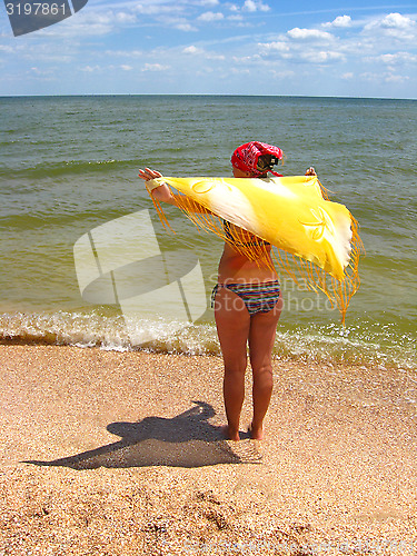 Image of The girl standing at the seacoast