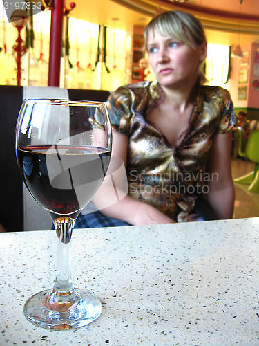 Image of the girl with glass of red wine in restaurant
