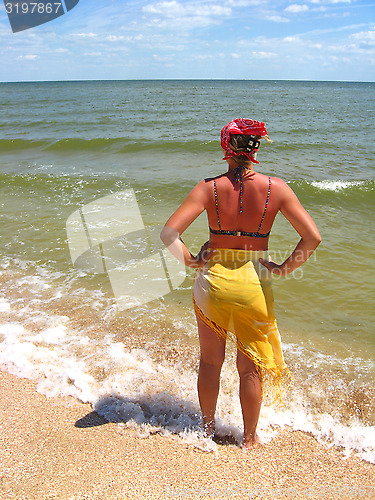 Image of The girl standing at the seacoast