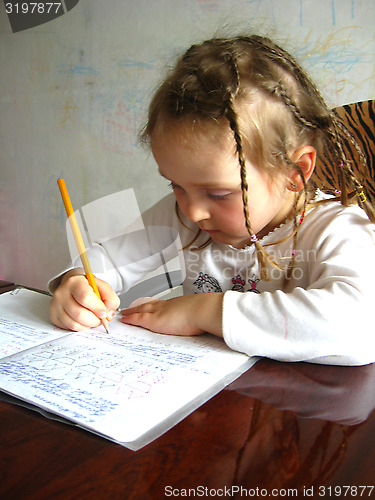 Image of the girl learning her  home tasks