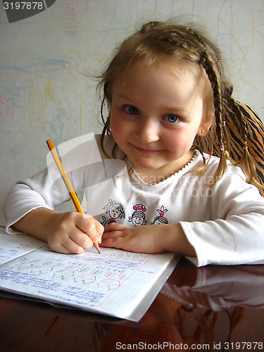 Image of the girl learning her  home tasks