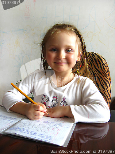 Image of the girl learning her  home tasks