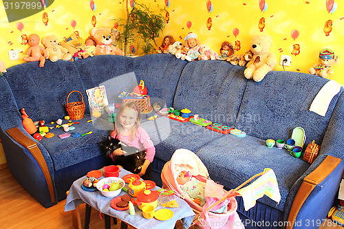 Image of little girl playing with toys in her room