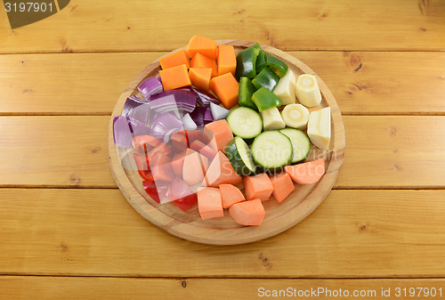 Image of Selection of chopped vegetables on a wooden chopping board