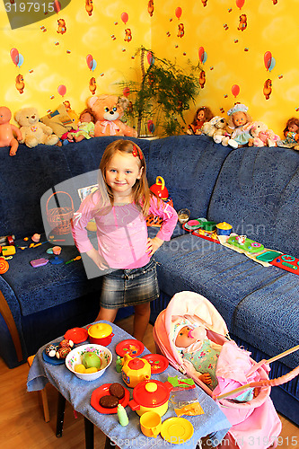 Image of little girl playing with toys in her room