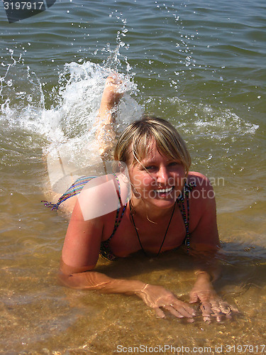 Image of girl splashing in the sea