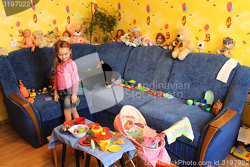 Image of little girl playing with toys in her room