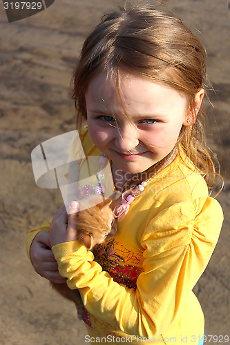 Image of little girl with little red kitten
