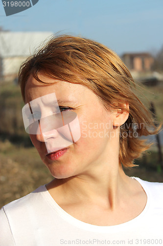 Image of blue-eyed sympathetic girl looking at the sky