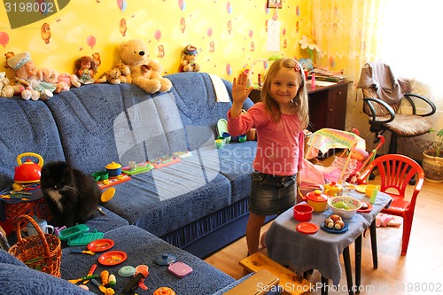 Image of little girl playing with toys in her room