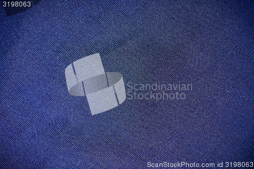 Image of Part synthetic clothes blue purple. macro