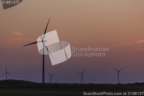 Image of Windmills silhouettes at sunrise