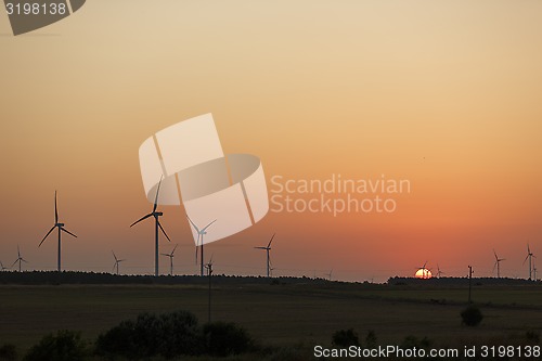 Image of Windmills silhouettes at sunrise