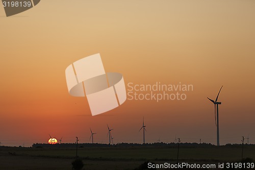 Image of Windmills silhouettes at sunrise