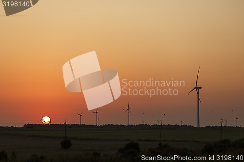 Image of Windmills silhouettes at sunrise