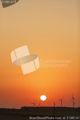 Image of Windmills silhouettes at sunrise