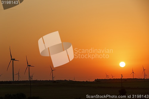 Image of Windmills silhouettes at sunrise