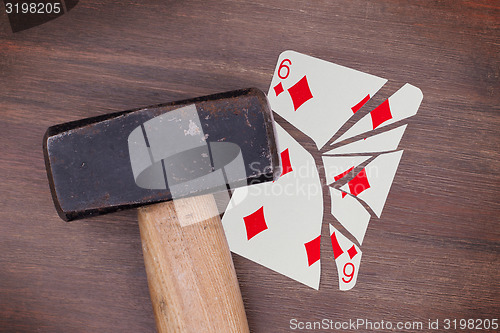 Image of Hammer with a broken card, six of diamonds