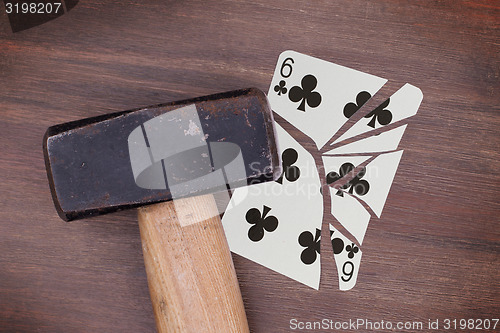 Image of Hammer with a broken card, six of clubs