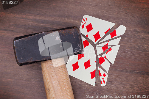 Image of Hammer with a broken card, ten of diamonds