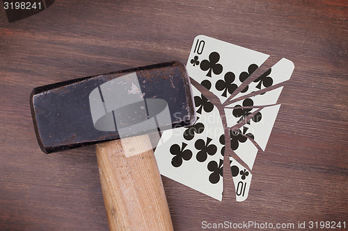 Image of Hammer with a broken card, ten of clubs