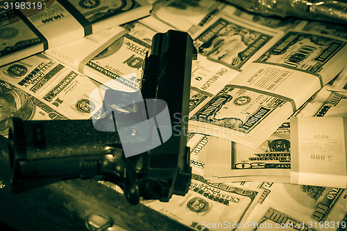 Image of gun and money