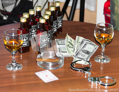 Image of money and glass of whiskey