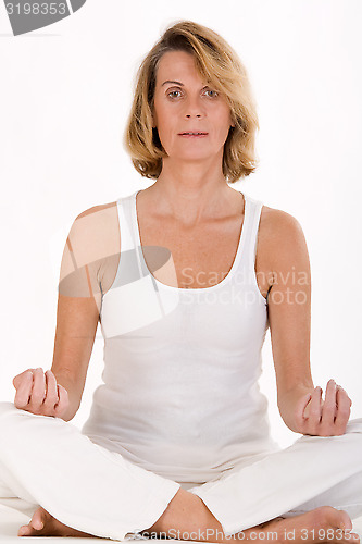 Image of older woman doing yoga in the stand