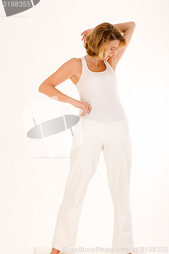 Image of older woman doing yoga in the stand