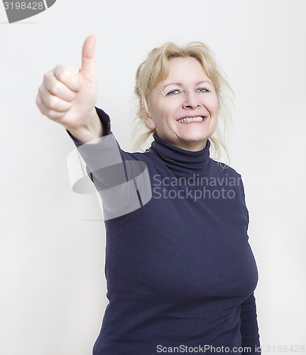 Image of Woman showing thumbs