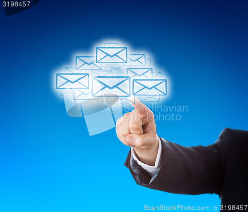 Image of Corporate Arm Reaching Into Cloud Swarm Of Emails