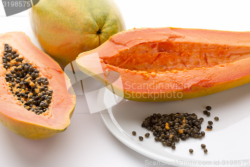 Image of Hollowed Out Papaya Half And Its Peppery Seeds